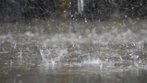 Heavy Rain Splashes On The Asphalt Macro Falling To The Ground Rain