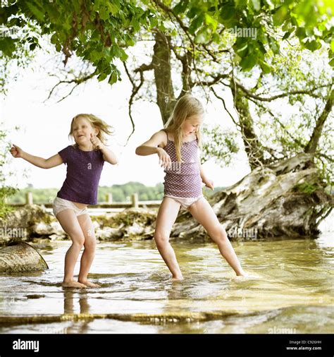 Smiling Girls Playing In Lake Stock Photo Alamy