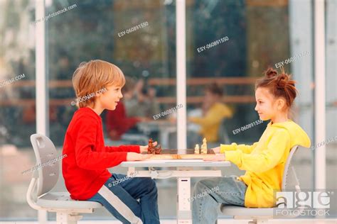 Little Kids Playing Chess At Kindergarten Or Elementary School Stock