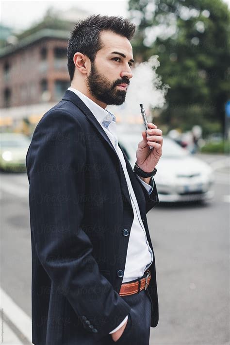 Businessman Smoking E Cigarette Outdoor By Stocksy Contributor Mauro Grigollo Stocksy