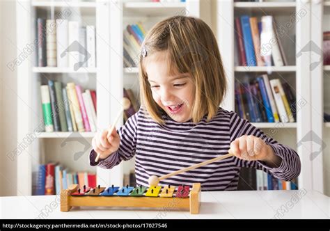 Portrait Of Happy Little Girl Playing Xylophones Stock Image