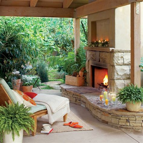 An Outdoor Living Area With Fireplace Couches And Potted Plants On The