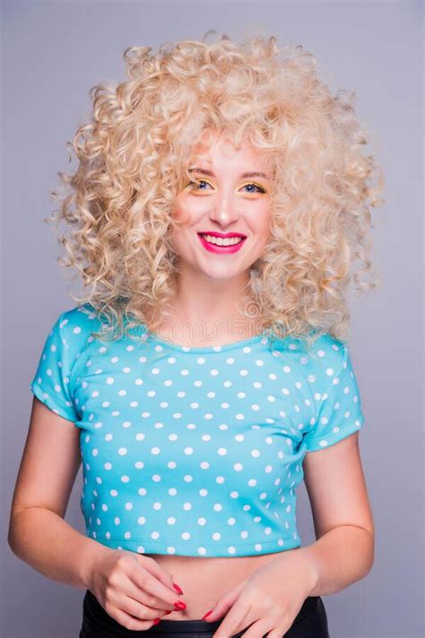 Beautiful Retro Style Blonde Girl With Voluminous Curly Hairstyle In A