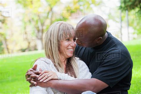Interracial Couple Embracing In A Park Edmonton Alberta Canada