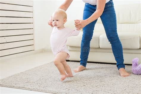 Baby Taking First Steps With Mother`s Help At Home Stock Image Image