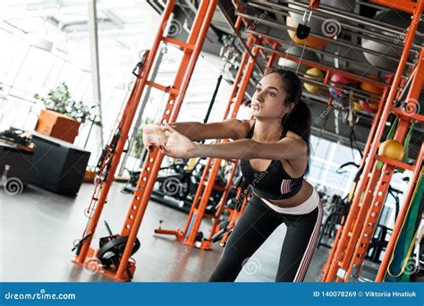 Young Woman In Gym Sporty Lifestyle Standing Bending In Front
