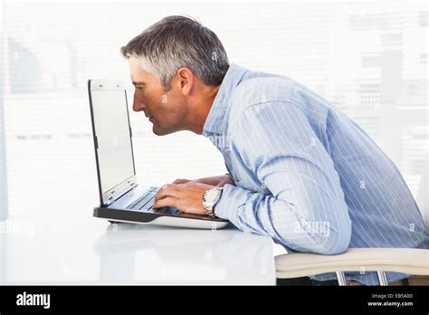 Businessman Looking Closely At The Laptop Stock Photo Alamy