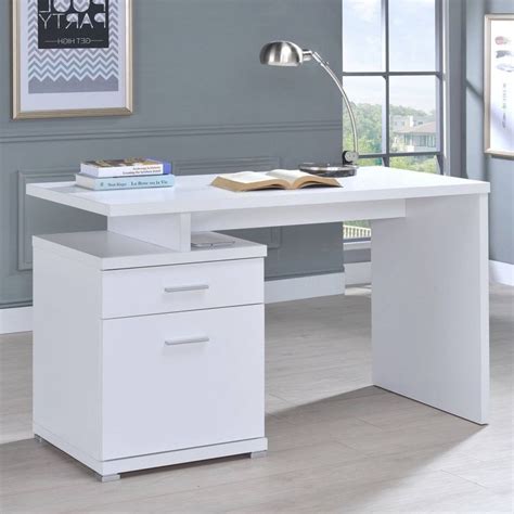 A White Desk With Two Drawers And A Lamp