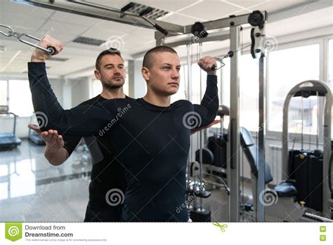 Personal Trainer Helping Client In Gym Stock Image Image Of Muscular