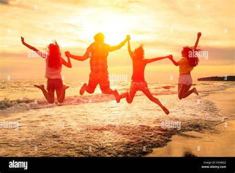 Group Of Happy Young People Jumping On The Beach Stock Photo Alamy