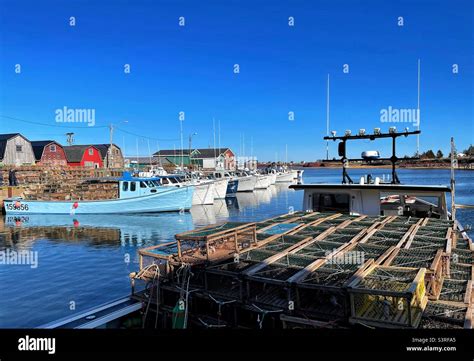 Fishing Boats Loaded With Lobster Traps And Tied Up At The Wharf In