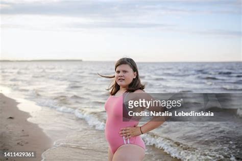 Teenage Girl Of 12 Years Old With Overweight In Pink Swimsuit Does