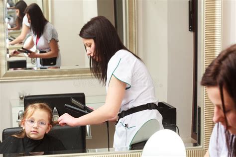 Hairdresser Straightening Hair Little Girl Child In Hairdressing Beauty