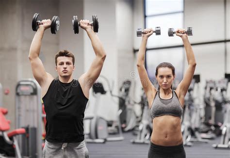 Smiling Man And Woman With Dumbbells In Gym Stock Image Image Of