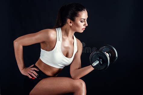 Athletic Young Woman Doing A Fitness Workout Against Black Background