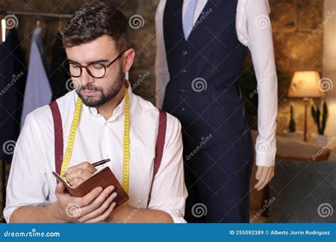 Fashion Designer Taking Notes On Traditional Note Pad Stock Image