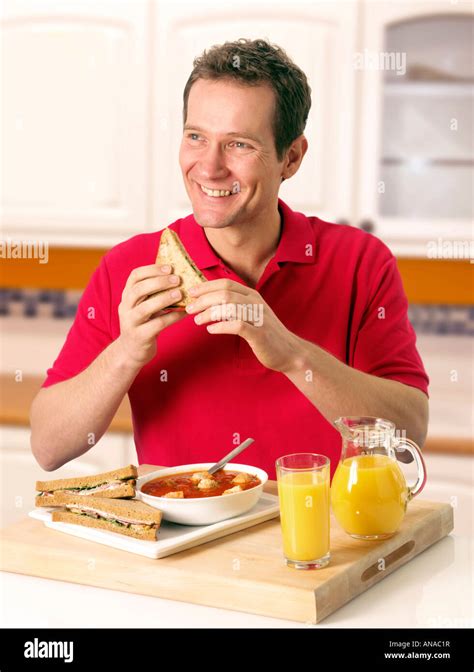 Man In Kitchen Eating Lunch Stock Photo Alamy