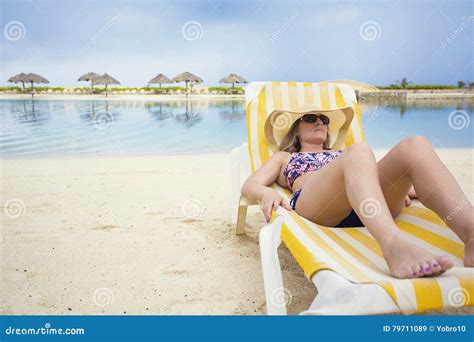 Beautiful Woman Relaxing In A Lounge Chair On A Tropical Beach Vacation Stock Image Image Of