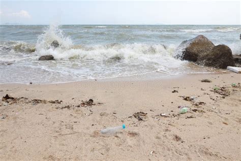 Angle View Image Of Empty Plastic Water Bottle On Dirty Beach Filled With Plastic Pollution