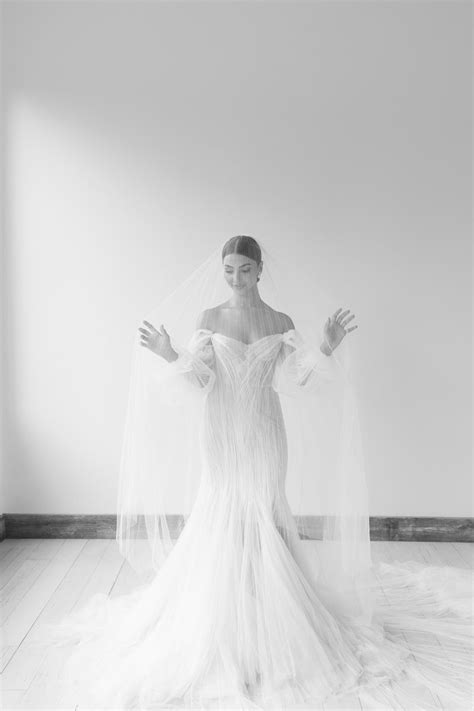 a woman in a wedding dress with her arms outstretched
