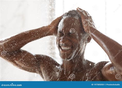 Black Man Washing Head And Body Taking Shower In Bathroom Stock Photo