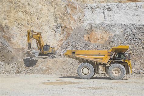 Loader Loading Mining Truck At Open Pit Stock Photo