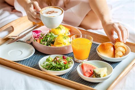 Young Smiling Beautiful Woman Having Breakfast In Bed In Cozy Hotel