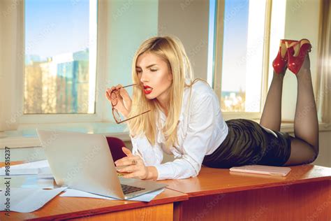 Sexual Blonde Office Secretary In Shirt Posing On The Table Stock Photo
