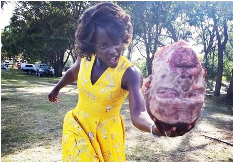 lupita nyong o plays with human head chopped off from the body