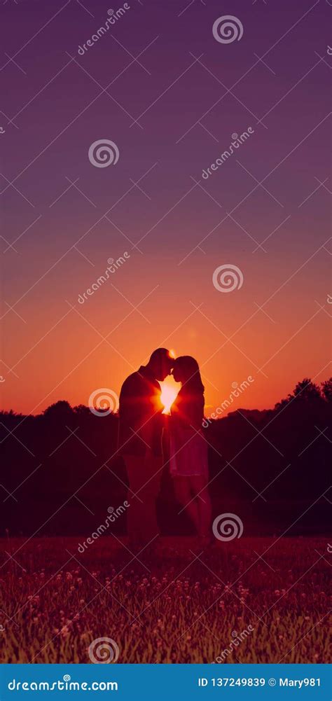 Young Happy Engaged Couple Silhouetted At Sunset Stock Image Image Of