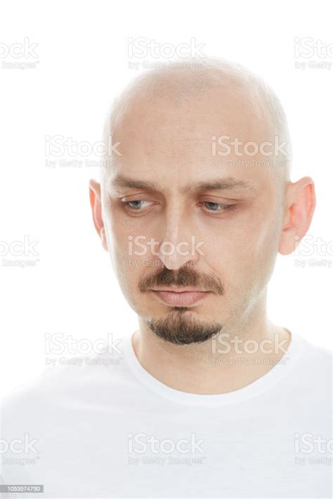 Portrait Of A Young Bald Man Looking Down In Pensive Attitude Stock