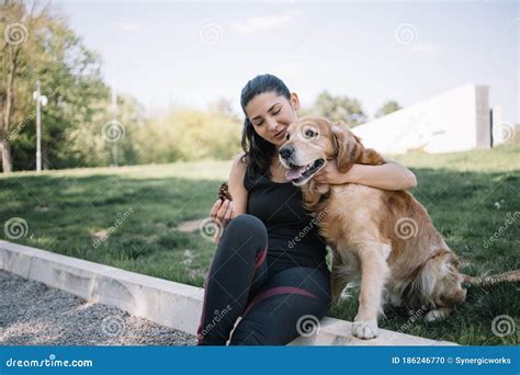 Young Woman Sitting On Ground And Hugging Dog Stock Photo Image Of