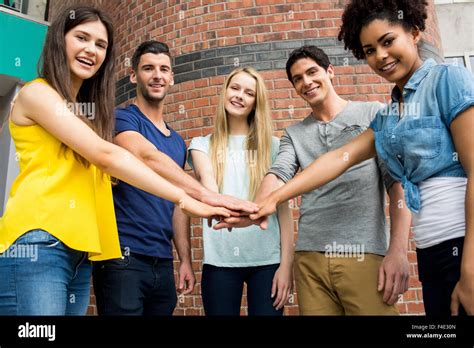 Students Putting Hands Together In Unity Stock Photo Alamy