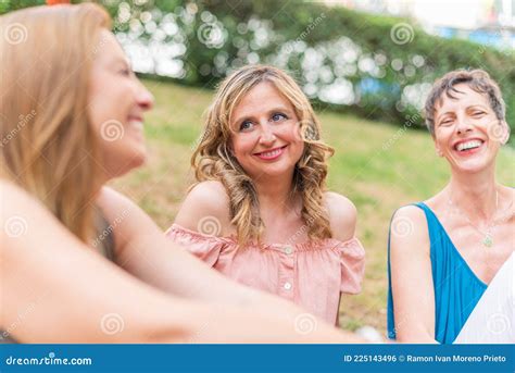 Close Up View Of Three Adult Women Sitting In The Park Laughing Stock