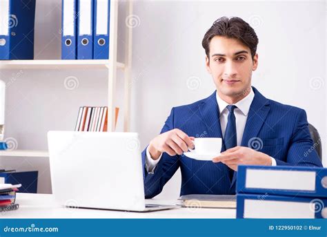 The Young Handsome Businessman Employee Working In Office At Desk Stock