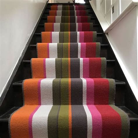 The Carpeted Stairs Are Lined With Multi Colored Striped Rugs And