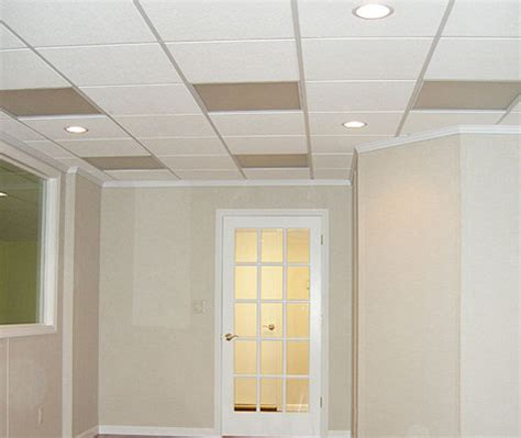 Installing a drop ceiling is expensive, makes it more difficult to access all the wiring/etc and reduces overhead space (which is already at premium). Basement Drop Ceiling Tiles | Basement Ceiling Finishing