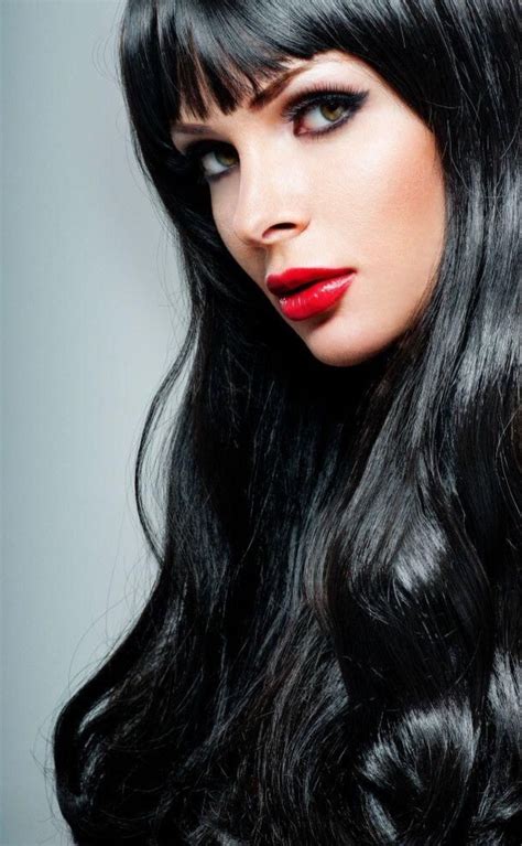 A Woman With Long Black Hair And Red Lipstick