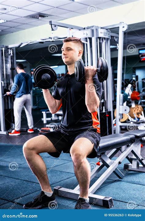 Handsome Young Sportive Male In Sportswear Lifting Some Weights Stock