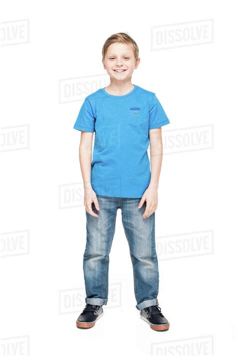 Full Length View Of Cute Little Boy In Jeans And Blue T Shirt Smiling