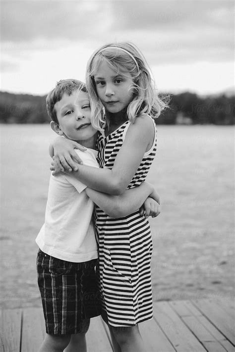 Brother And Sister Looking Serious And Hugging By Stocksy Contributor