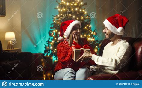 Boy Surprises His Girlfriend With Christmas Present Stock Photo Image