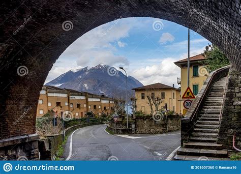 Italy Varenna Lake Como Snow Capped Maountain Viewed Under An Arch