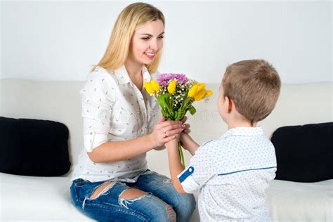 Son Gives His Beloved Mother A Beautiful Bouquet Of Tulips Stock Image