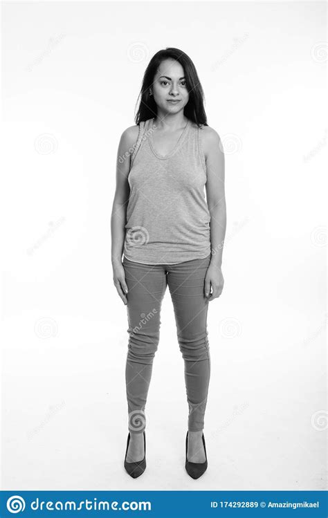 Full Body Shot Of Beautiful Woman Standing Against White Background