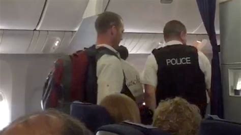 passenger films man being escorted off plane in belfast