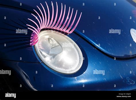 Blue Volkswagen Beetle With Pink Eyelash Over The Headlamp Stock Photo