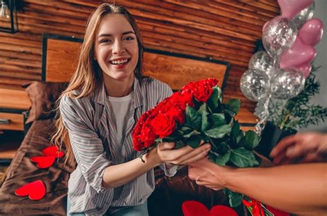 Premium Photo Cropped Image Of Man Gives A Woman A Red Roses
