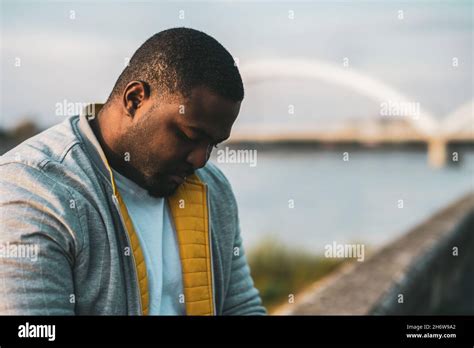 Depressed Black Man Sitting Outdoor Stock Photo Alamy