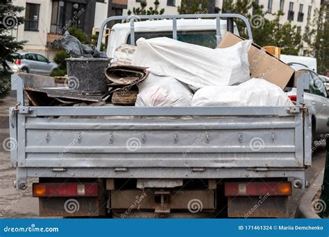 An Open Truck Body Filled With Various Rubbish Bags Cardboard